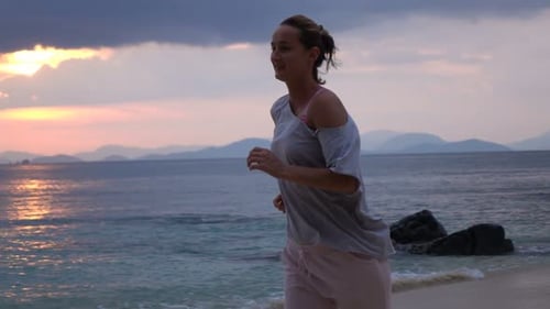 Young Woman Jogging on Beach During Sunset, Super 240