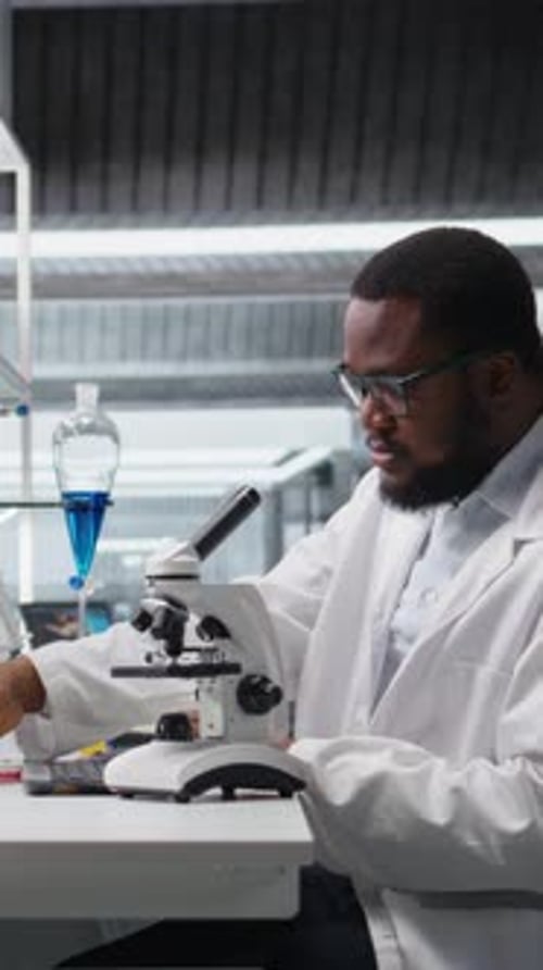 Scientist using microscope in a laboratory for research