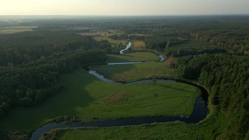 Verdant landscape scenery, river waterway, sunset horizon, aerial view
