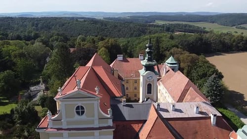 Drone is flying passing by a Church tower from above. Old Austrian Church in Heiligenkreuz Gutenbrun