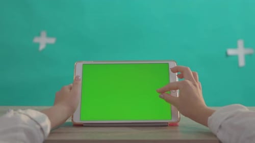 Hands Interact with Green Screen Tablet