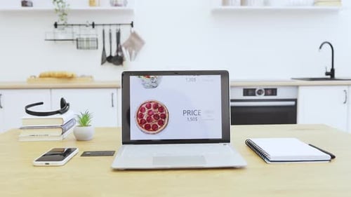 Online Food Ordering with Pizza Displayed on Laptop Screen