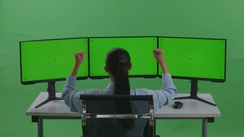 Happy Woman Celebrating And Dancing While Working With Mock Up Multiple Monitor In Green Screen