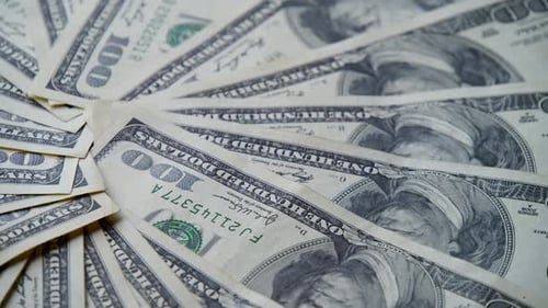 Spinning Hundred Dollar Banknotes On Tabletop Represent Financial Success Wealth