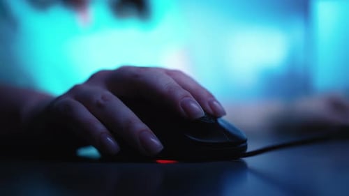 Nahaufnahme einer weiblichen Hand, die an einer Maus arbeitet und im Hintergrund die Farben wechselt Freelance