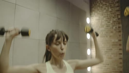 Group of adult women exercising with weights in gym