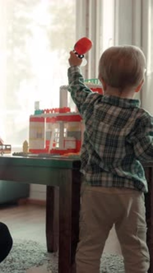 Child Plays with Toy Race Track Set