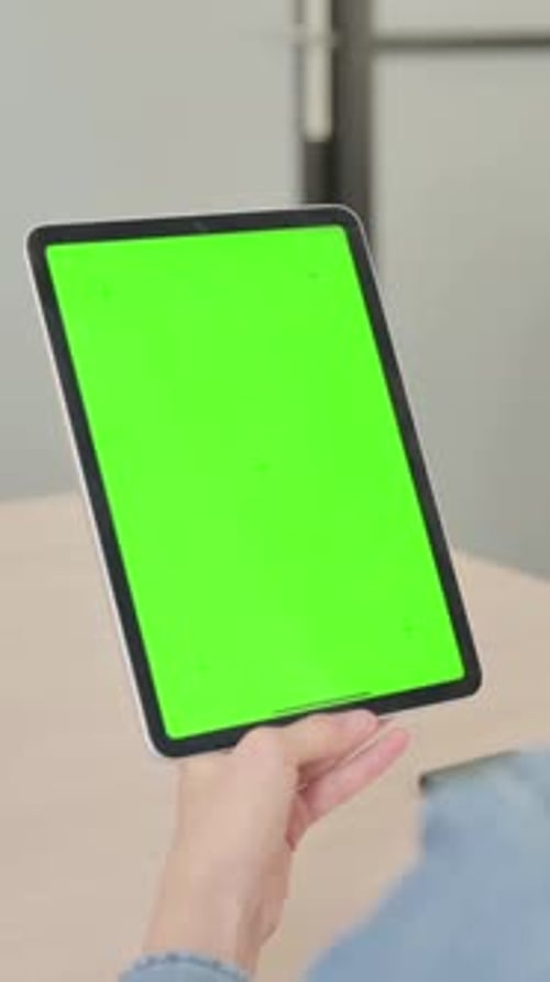 Young Woman using Tablet with Green Screen, Vertical Video