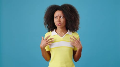 Disappointed AfricanAmerican Woman on Blue Background