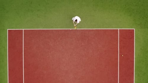 Aerial View of Tennis Player Hitting Ball