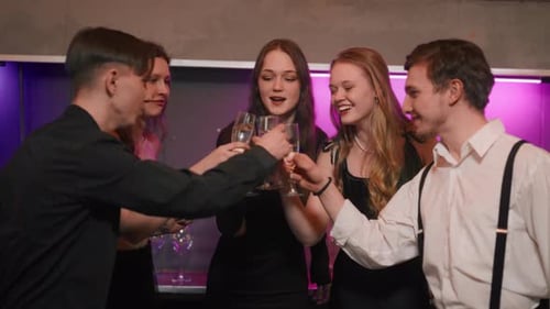 Young Adults Celebrate Birthday with Champagne Toast