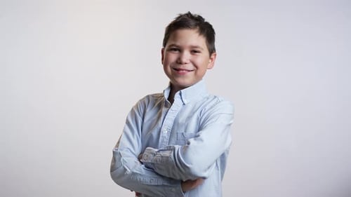 Smiling Boy in Blue Shirt with Crossed Arms