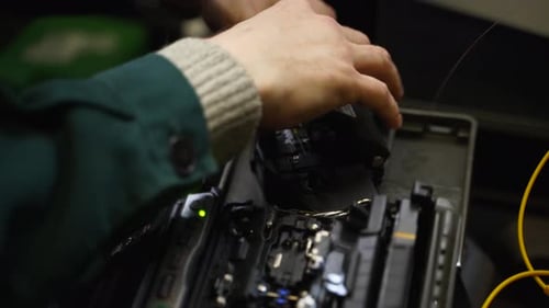 Technician Working with Fiber Optic Fusion Splicer