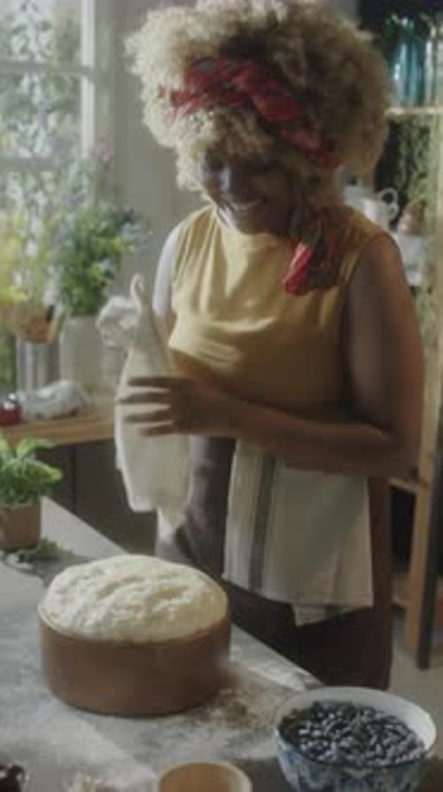 Woman Kneading Dough in Kitchen at Home