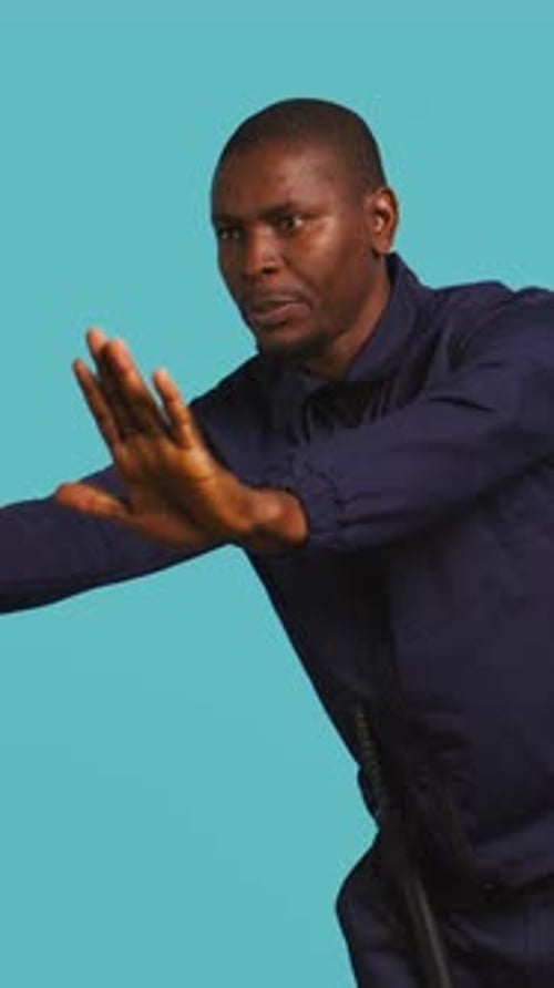 Man Gesturing Stop with a Baton on Blue