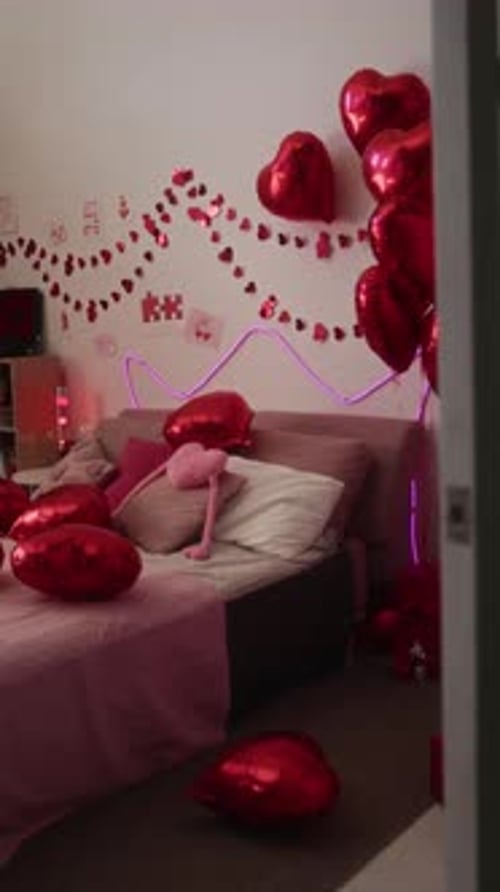 Cozy Bedroom Decorated with Red Balloons and Garlands in Romantic Setting
