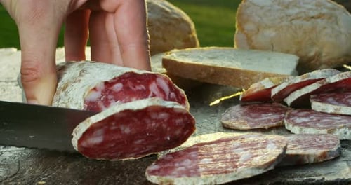 Slicing Salami Close Up with Bread
