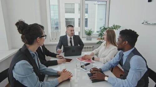 Team Celebrates Success with High Fives in Office