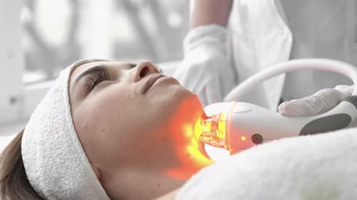 Woman Receiving Laser Facial Treatment for Skincare