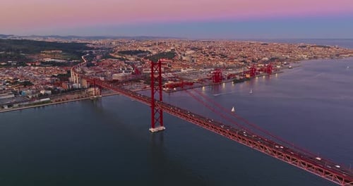 Aerial View of 25 De Abril Bridge Over the Tagus River at Sunset in Lisbon Portugal