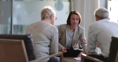 Businesswoman Meeting with a Mature Couple in Office