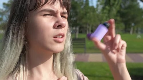 Teen Use an Inhaler From Allergy