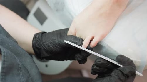 Adult getting pedicure service filing toe nails