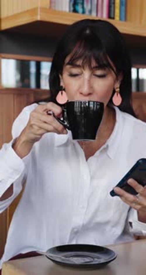 Happy woman, customer and drinking with phone in coffee shop for latte, cappuccino or beverage