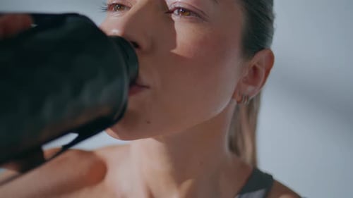 Close up of Woman Drinking Water from Bottle