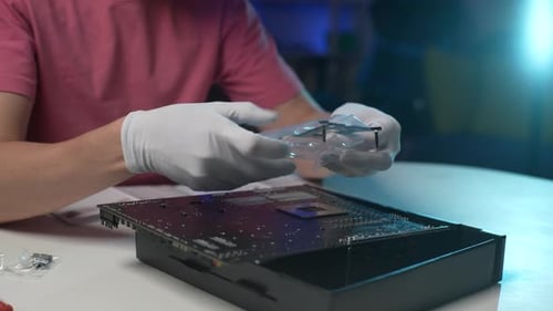 Closeup Cropped Shot of Unrecognizable Technician Male Installing Frame on Motherboard to Mount PC