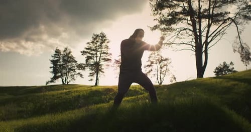 Silhouette of Boxer Training Outdoors at Sunrise