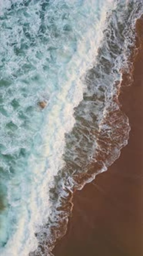 Foamy Ocean Washing Sand Vertically Closeup Turquoise Water Rolling Seashore