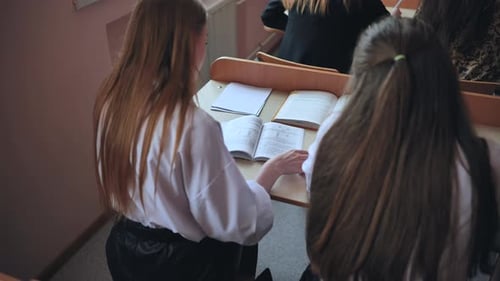 Students Reading Books in Classroom