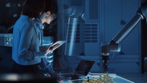 Two Development Engineers are Discussing and Testing an Artificial Intelligence Interface by Playin