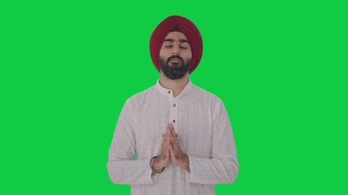 Religious Sikh Indian man praying to God Green screen