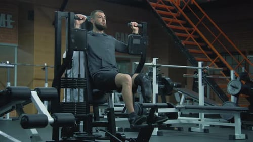 Man with Prosthetic Leg Works Out at Gym