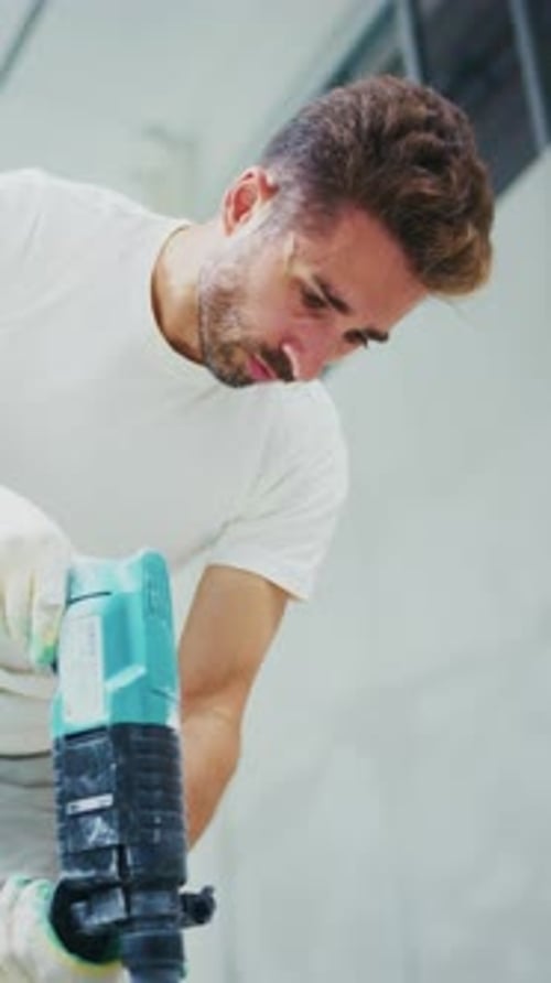 A Focused Individual Using a Power Tool in a Workshop Setting Demonstrating Precision and Skill