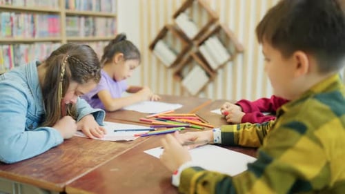 Side view Group of young boy and girls enjoy to learn or study in drawing classroom school