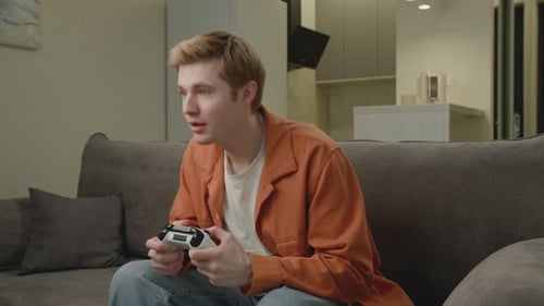 Young Adult Plays Video Game at Home and Wins