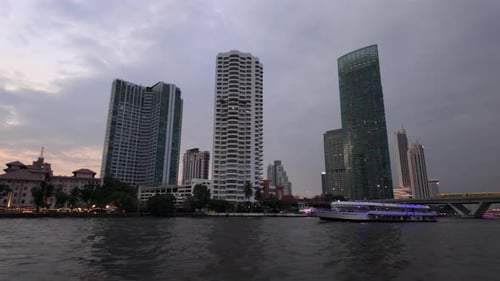 Bangkok Riverside Skyline at Dusk with River Cruise Boat