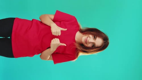 Enthusiastic Woman Giving Thumbs Up on Green Background