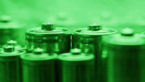 Silver Batteries AA and AAA in Neon Light Closeup DoubleA Battery is a Standard Size Single Cell