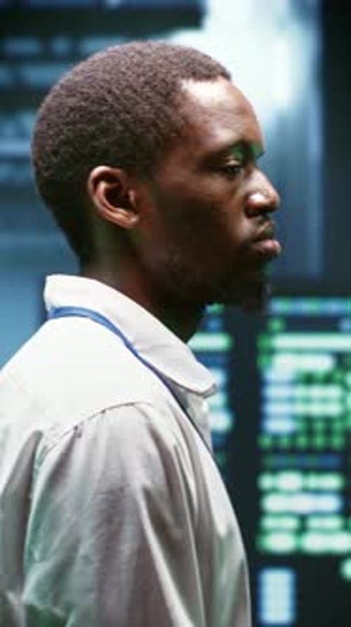 Adult Stands Near Data Server Units