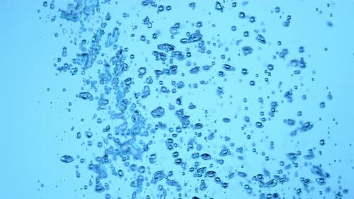 Bubbles rising in clear blue water background