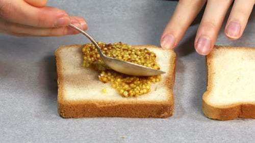 Mustard Spread on White Bread with Spoon