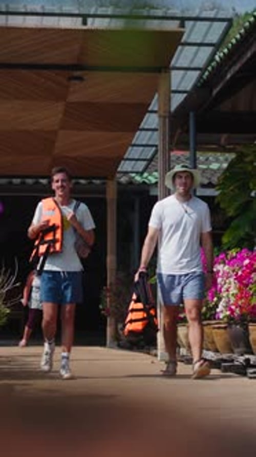 Two Boys Walk to the Lake in Life Jackets Before Kayaking