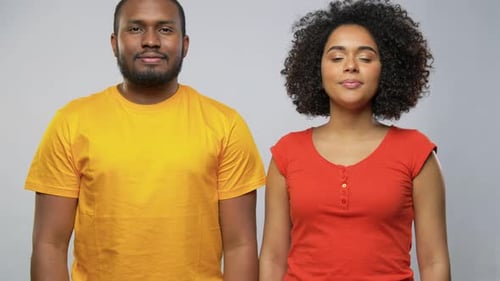 Smiling Young Adult Couple Embracing Affectionately Indoors