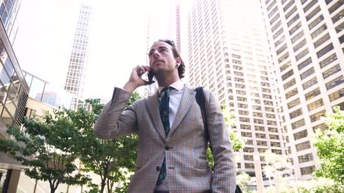 Businessman Talking on Smart Phone Below City Highrise Buildings Adult