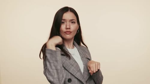Brunette Woman Dancing Joyfully in Studio