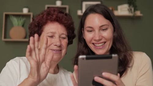 Woman and Senior Woman Video Chatting on Tablet